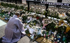 At a makeshift memorial close to the narrow alleyway at the epicenter of the disaster, Buddhist monks chanted prayers for the dead