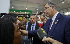 Total Energies CEO Patrick Pouyanne (R) speaks with activists at the COP27 UN climate conference where he was heckled by others angered by the presence of fossil fuel lobbyists