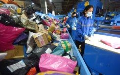 An employee sorts packages for delivery during the Singles Day shopping festival at a logistics center in Donghai, China