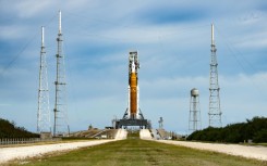 Engineers work on the Tail Service Mast Umbilical of the Artemis I unmanned lunar rocket as it sits on launch pad 39B at NASA's Kennedy Space Center