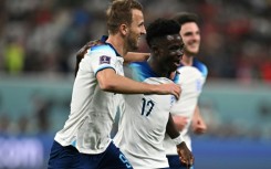 England's Bukayo Saka celebrates with Harry Kane