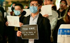 People gather to protest the Chinese governments continued continued zero-Covid policies at the University of California Berkeley campus in Berkeley, California