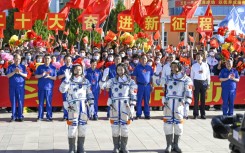 Chinese astronauts Cai Xuzhe (L), Chen Dong (C) and Liu Yang -- seen in June 2022 prior to their mission to the Tiangong space station -- have returned safely to Earth, state media reported