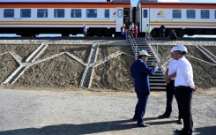 Chinese builders stand next to the Standard Gauge Railway train at Mai Mahiu, Kenya, in October 2019