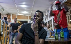 Morocco supporters react while watching a live broadcast of the semi-final match between Morocco and France in Central African Republic