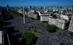 Vast crowds wait for the Argentina players' bus parade in central Buenos Aires to celebrate after winning the Qatar 2022 World Cup