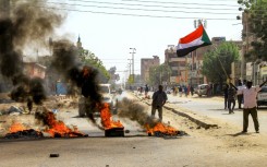 Sudanese protesters took to the streets Monday against a tentative deal aimed at ending the crisis provoked by last year's military coup