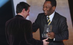 Hand it over: Lionel Messi receives a FIFA World XI award from Pele in 2012