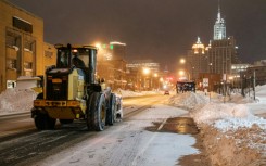 An excavator makes its way through Buffalo, New York on December 27, 2022