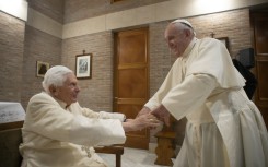 Pope Francis (R) sparked alarm on Wednesday by revealing at his general audience that his predecessor, former pope Benedict (L), was "very ill"