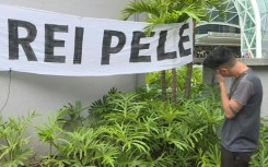 Pele fans mourn his death outside the hospital in Sao Paulo where he was treated 