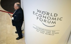 A participant uses his mobile phone at the Congress centre during the World Economic Forum (WEF) annual meeting in Davos on January 18, 2023