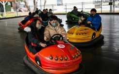 People enjoy a bumper car ride at Zhongshan Amusement Park in Wuhan