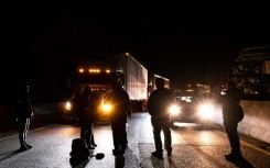 Protesters block traffic as they rally against the fatal police assault