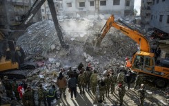 Rescue workers search for survivors in the town of Jableh in northwestern Syria