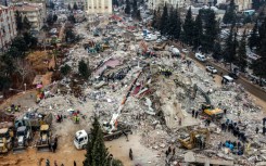 Rescue workers look for survivors in the rebel-held town of Jindayris in Syria