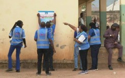 Electoral officials prepare to open a polling station