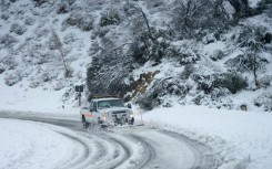 Snow has snarled mountain roads around southern California, as a brutal, and unusual, winter storm grips the area