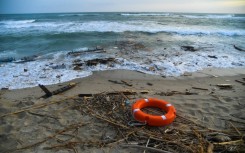 Bodies, shoes and debris have washed up along a stretch of southern Italy shoreline after a migrant boat sank