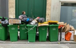 Bins overflow in Paris as workers strike over pension reform 