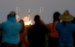 People watch as a SpaceX Falcon 9 rocket lifts off at Cape Canaveral Space Force Station on February 27, 2023 