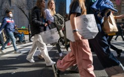 Pedestrians stroll along 5th Avenue in Manhattan, a premier shopping street in New York City  