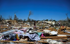 A woman in Rolling Fork, Mississippi walks amid the remains of homes destroyed by a massive tornado that ravaged parts of the southern US state, killing at least 25 people and leaving dozens of others injured