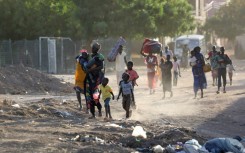 People flee their neighbourhoods amid fighting between the army and paramilitaries in Khartoum