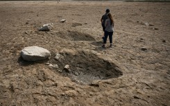 Members of the public walk through a debris field near the SpaceX launch pad on April 22, 2023