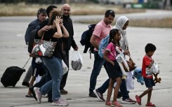 Greek nationals from Sudan arrive with a military C-27 plane at the military airport of Elefsina, south of Athens