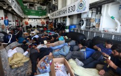 Evacuees rest on the Saudi Arabian warship HMS Al-Diriyah, transporting them from Port Sudan to Jeddah