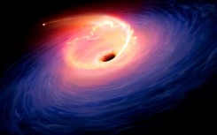 An artist's illustration of a star being sucked into a black hole -- just one theory for what caused the largest explosion astronomers have observed