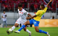 Wydad Casablanca defender Ayoub el Amloud (L) and Mamelodi Sundowns midfielder Sipho Mbule clash during a CAF Champions League semi-final first leg in Morocco.