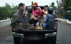 People evacuate in Sittwe in Myanmar's Rakhine state on May 13, 2023, ahead of the expected landfall of Cyclone Mocha on May 14