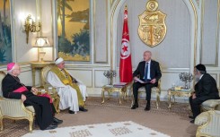 Tunisian President Kais Saied, seated next to the flag, meets Bishop Ilario Antoniazzi, Chief Rabbi Bitten Haiem and Mufti Hichem Ben Mahmoud at the Carthage Palace in Tunis