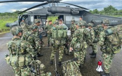 Soldiers board a helicopter to search for the lost children, in this handout photo from the Colombian armed forces