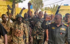 Sudan's army chief Abdel Fattah al-Burhan cheering with soldiers as he visits some of their positions in Khartoum