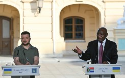 Ukraine's President Volodymyr Zelensky (l) listens on as South Africa's President Cyril Ramaphosa addresses the media in Kyiv on Friday