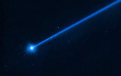 The small spots of light around the asteroid Dimorphos are boulders sent off by the impact of the NASA probe, a Hubble telescope image shows