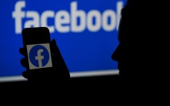 File: Facebook page on a computer and app. AFP/Olivier Douliery