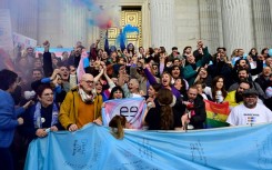 Spanish activists celebrate a vote in favour of the country's transgender rights bill