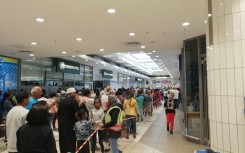 People queue in Cape Town to get their final shopping in before the 21-day lockdown.