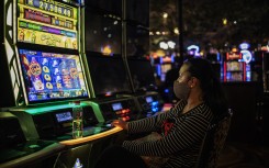 A woman gambles at the Montecasino complex after government allowed casinos, cinemas and restaurants to resume their activity.