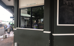 Flowers placed on a window sill at Poppy's restaurant in Melville following a deadly shooting.