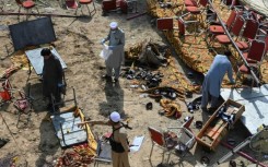 Investigators examine the site of Sunday's suicide bomb blast