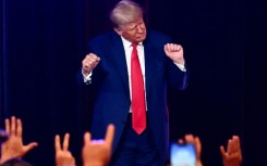 Former US president and 2024 Republican presidential hopeful Donald Trump, pictured dancing at a campaign event, is facing multiple felony charges