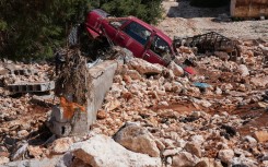  A car is buried in rubble and debris in the aftermath of a devastating flood in al-Bayda town in eastern Libya. AFP