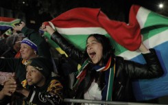 South African rugby supporters celebrate at the Bree Street fan park in Cape Town. AFP/Gianluigi Guercia