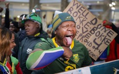 A supporter reacts ahead of the South African rugby team's arrival at the OR Tambo International airport in Ekurhuleni on October 31, 2023, after they won the France 2023 Rugby World Cup final match against New Zealand.