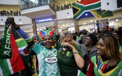 Supporters react ahead of the South African rugby team's arrival at the OR Tambo International airport in Ekurhuleni on October 31, 2023, after they won the France 2023 Rugby World Cup final match against New Zealand. 